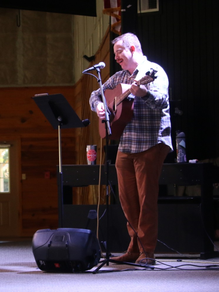 Grant playing guitar on retreat